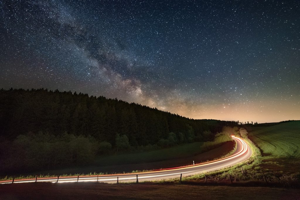 A long exposure showing a streak of headlights on a road's bend near Lancaster, OH